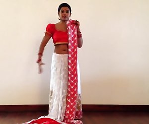 Indian girl giving lesson to young girls how to agitate a sari. This is our latest updated flick for your viewing pleasure.